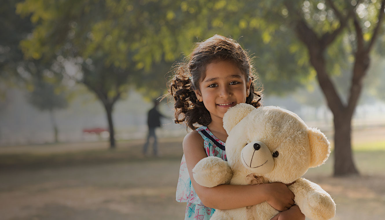 happy child holding a teddy bear